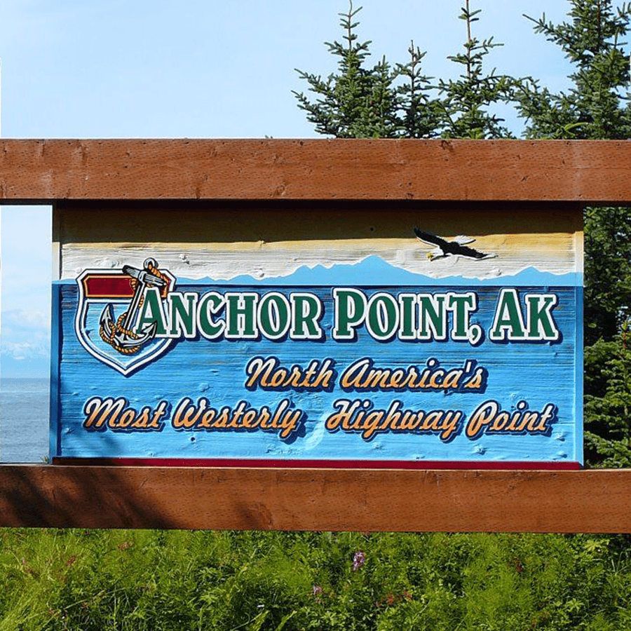 Sign for Anchor Point, Alaska, marking it as North America's most westerly highway point.