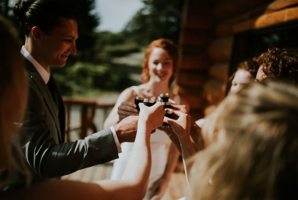 A group of people toasting with cameras in a joyful celebration.